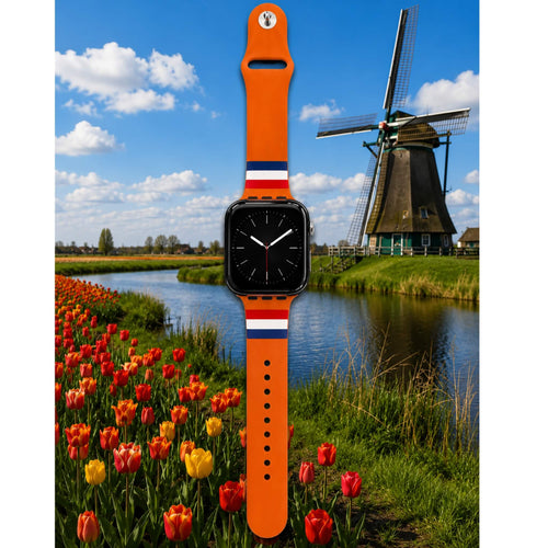 Oranje Holland Apple Watch bandje van BNationX met rood-wit-blauwe details, geïnspireerd op de Nederlandse vlag. Silicone smartwatch band afgebeeld bij typisch Nederlands landschap met molen en tulpenvelden.