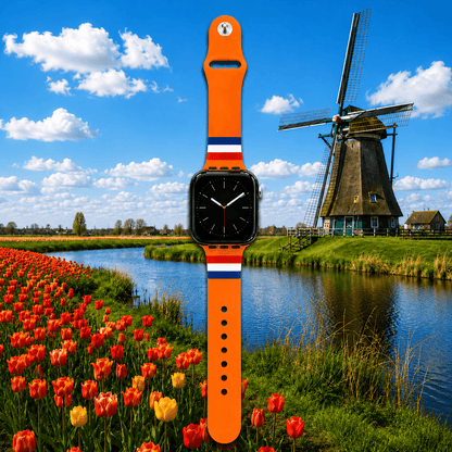 Oranje Apple Watch-bandje met Nederlandse vlag, gefotografeerd bij een Nederlandse molen en tulpenveld.