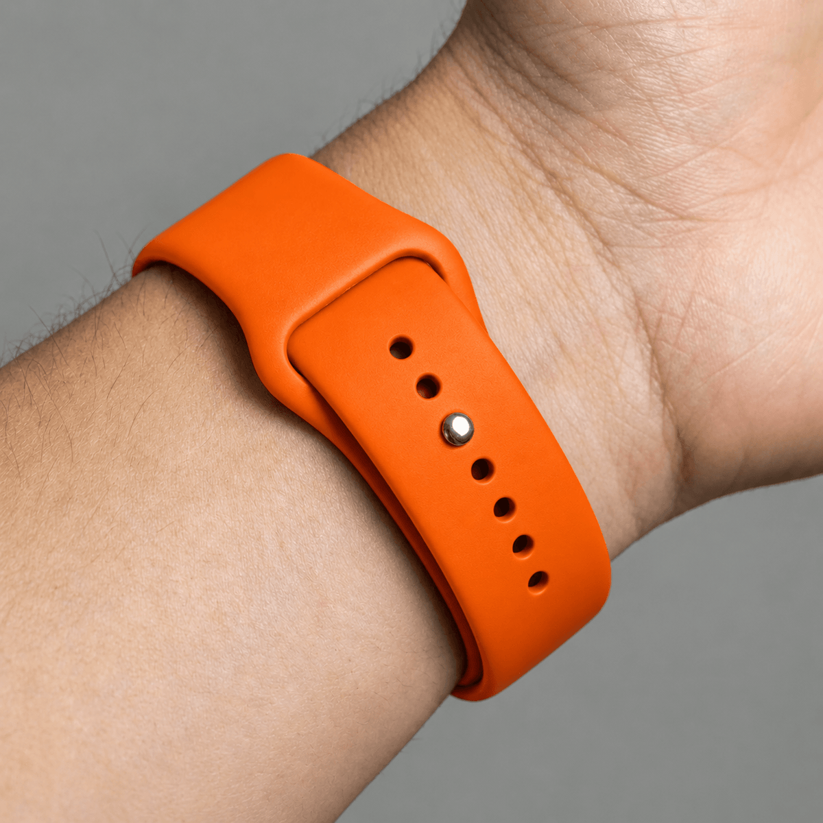 Oranje BnationX Nederland Apple Watch-bandje om de pols, close-up van siliconen horlogebandje.